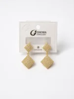 Luxury geometric drop earrings with sparkling crystal stones worn by a woman, featuring a modern square dangle design.