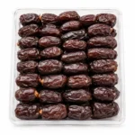 Close-up of Premium Kalmi Dates showing their soft texture, glossy appearance, and rich brown color